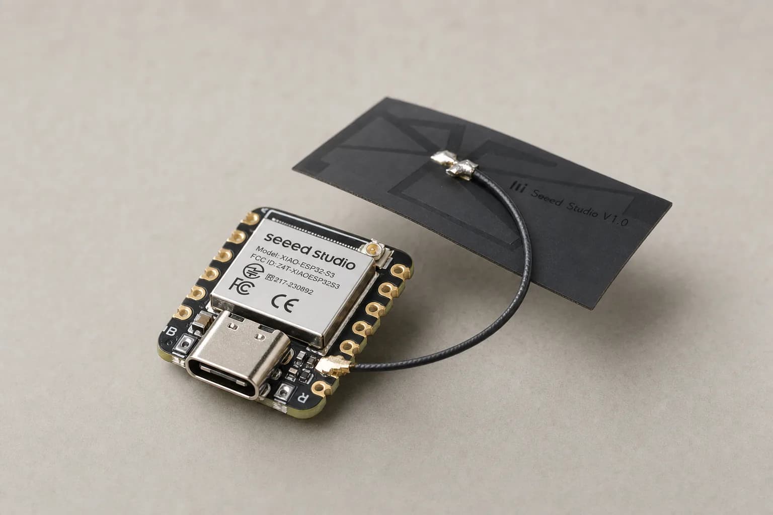 Seeed Studio XIAO ESP32-S3 board with its flat black Wi-Fi antenna attached, USB-C port facing forward